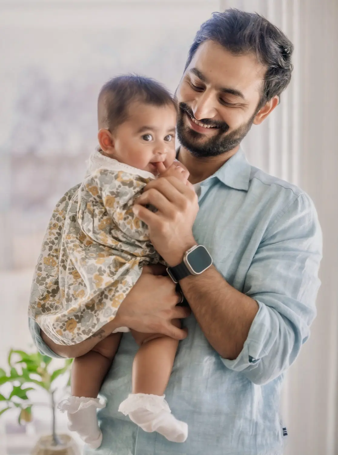 Arya in her dad's arms by the window